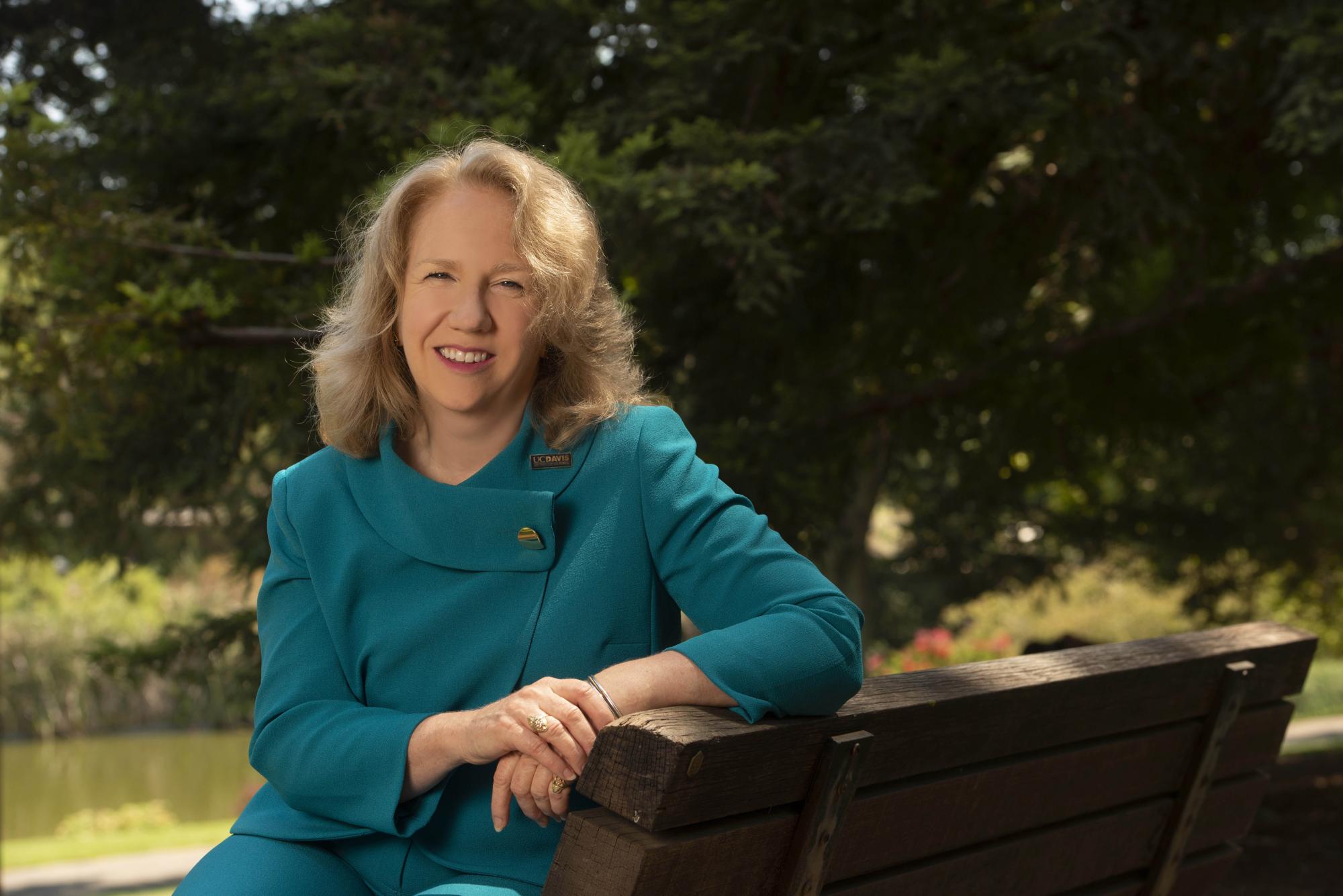 Provost Mary Croughan sits on bench in UC Davis arboretum
