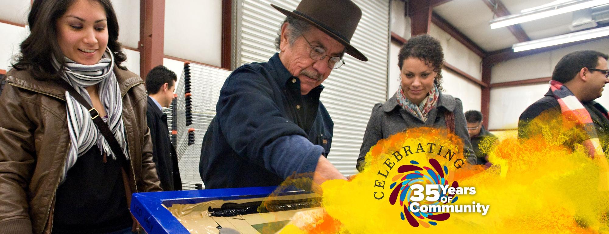 Group of people in a workshop setting engaging in an activity, the words "Celebrating" with a colorful "35 Years of Community" graphic overlay. 