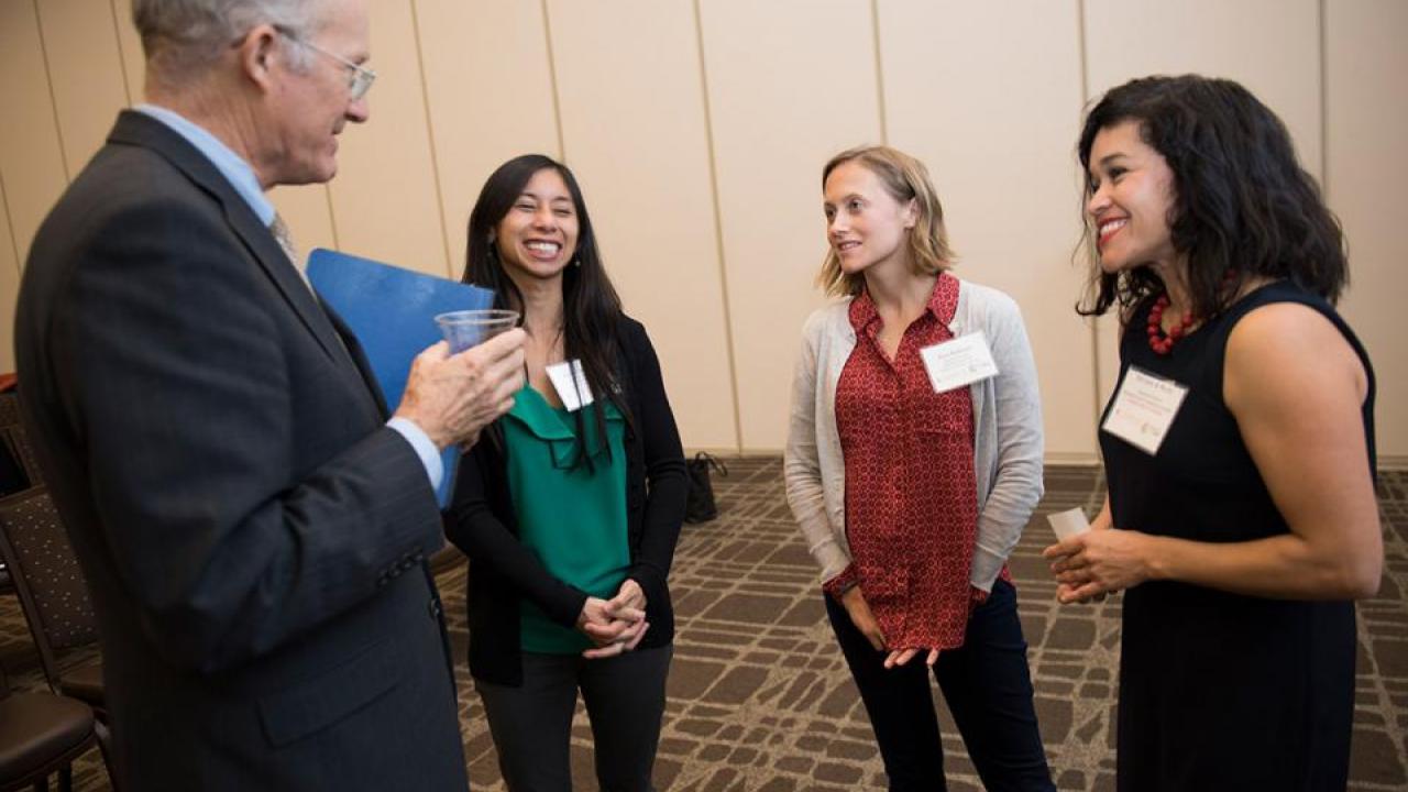 Ken Burtis, faculty advisor to the chancellor and provost, welcomes new CAMPOS faculty scholars Marie Cuevas Heffern, Kara Rudolph and Miriam A. Nuño. (Karin Higgins/UC Davis)