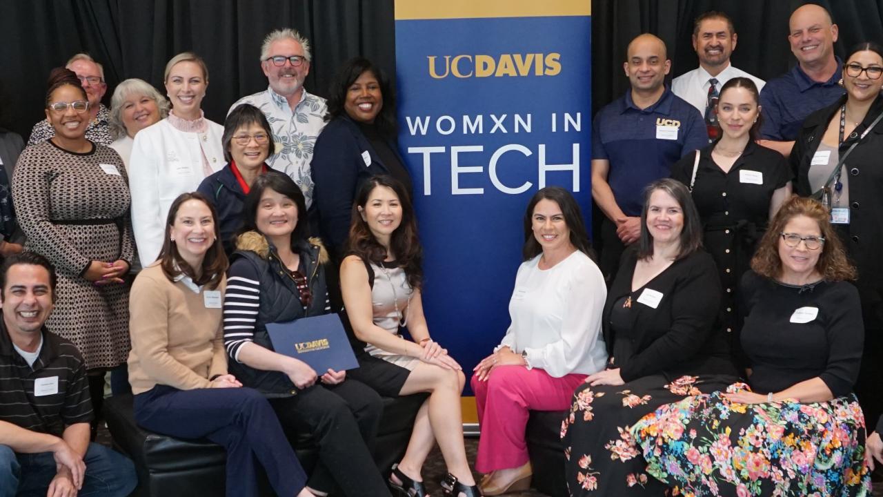 Attendees of the Womxn in Tech March 2024 event stand together.