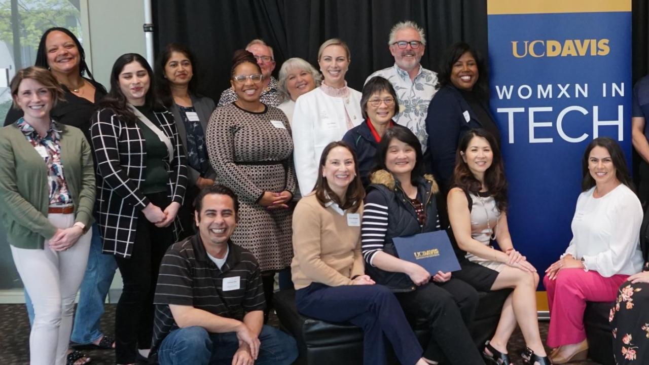Attendees of the Womxn in Tech March 2024 event stand together.