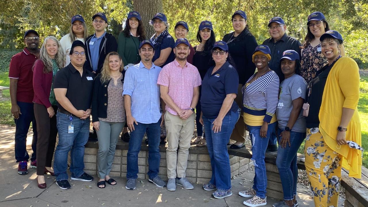 members of the academic advisory committees stand together for a group picture in the UC Davis Arboretum