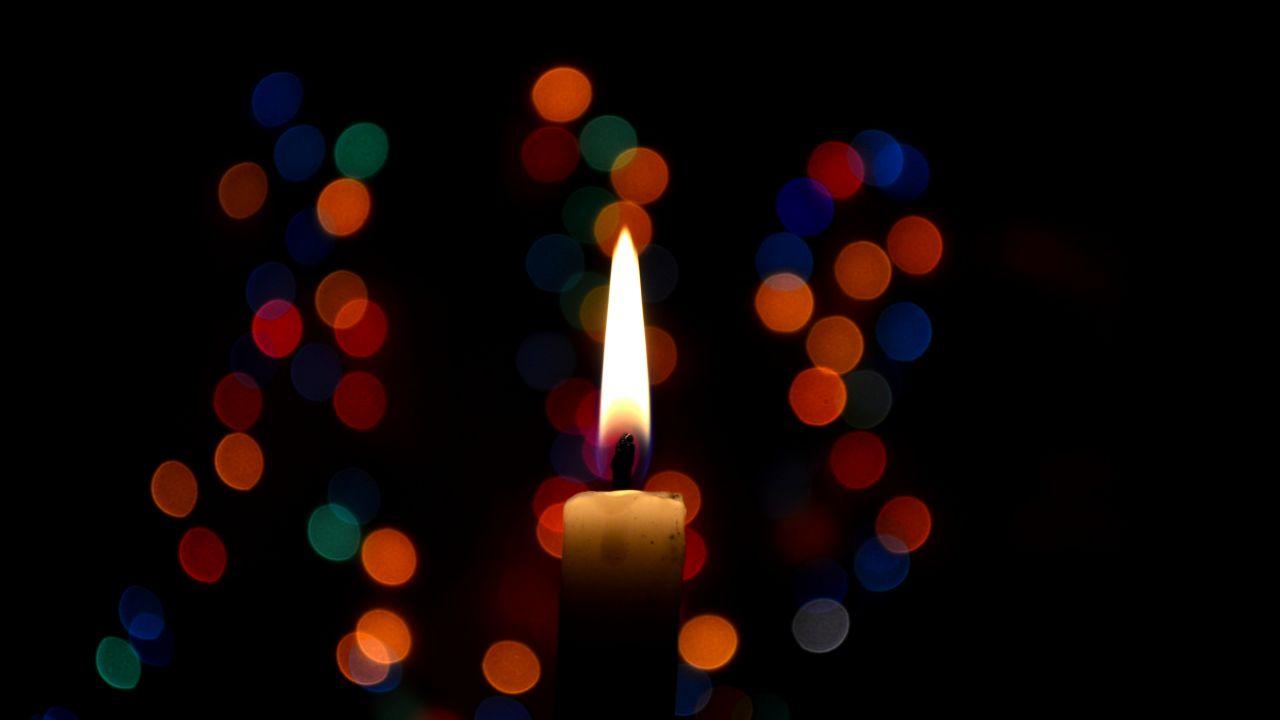 Candle with colored bokeh lights