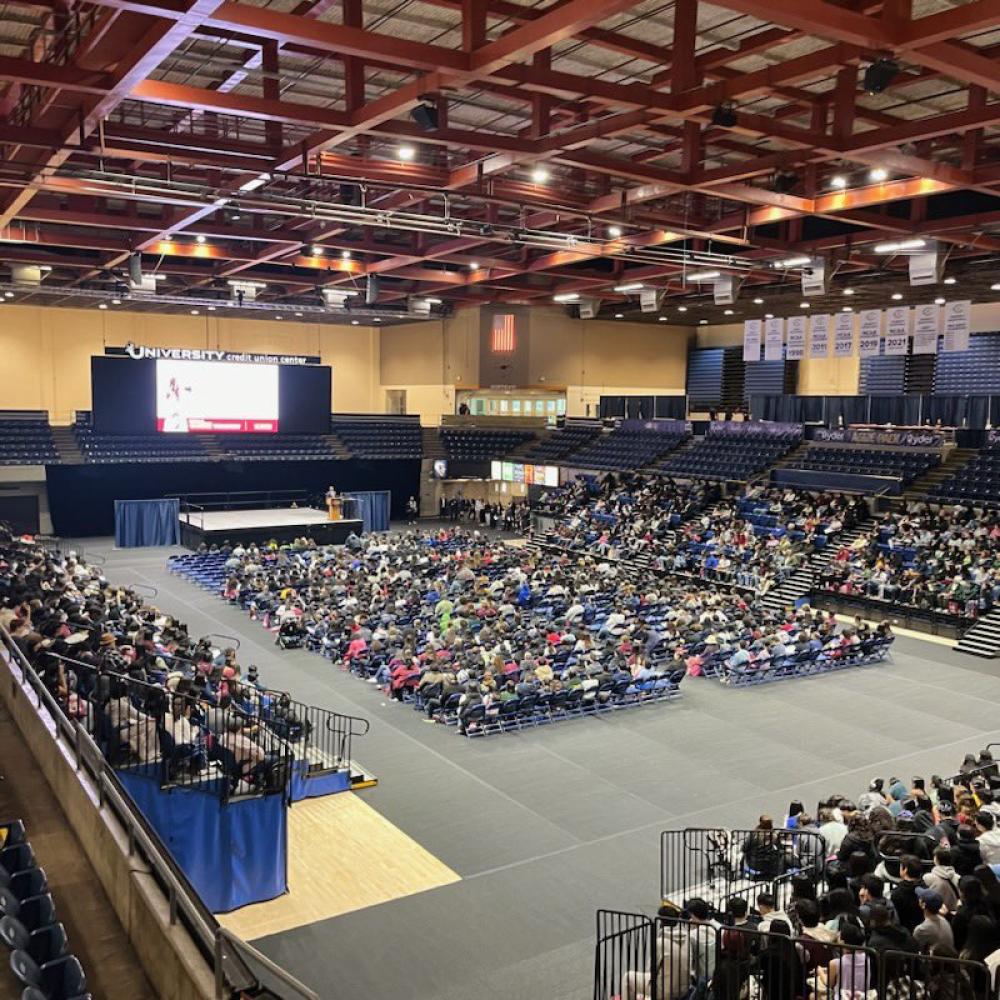Large crowd in University Credit Center on UC Davis campus.