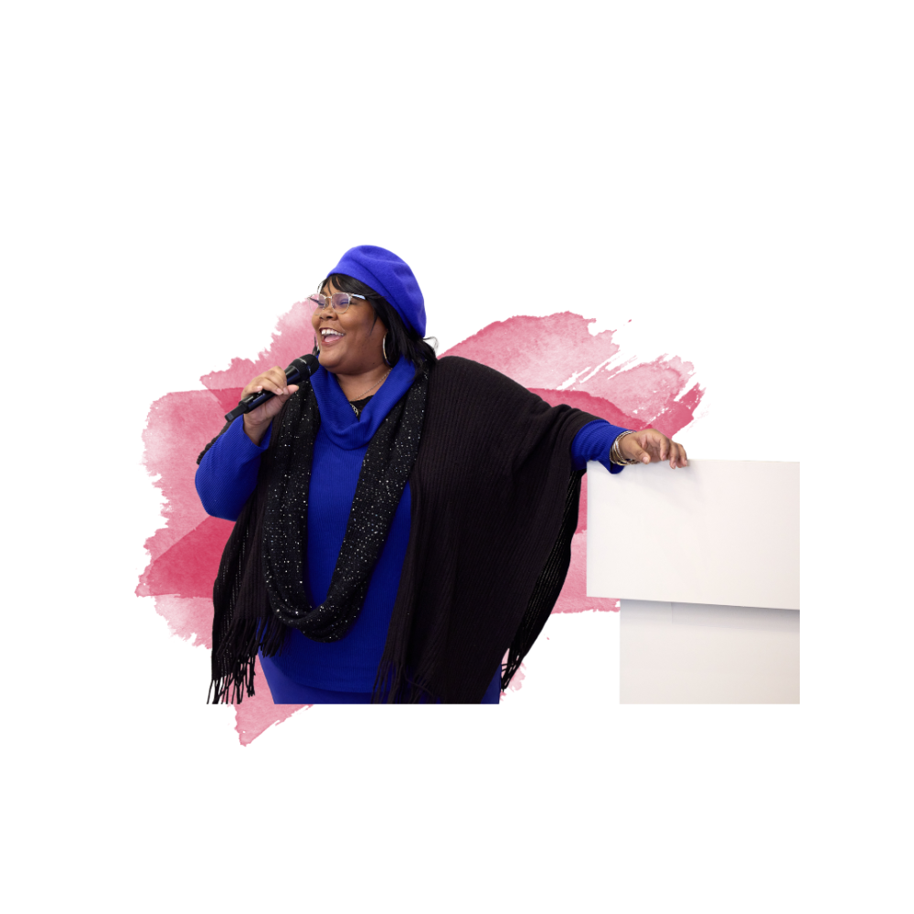 Woman in a blue outfit with a beret, holding a microphone and smiling, against a pink watercolor background.