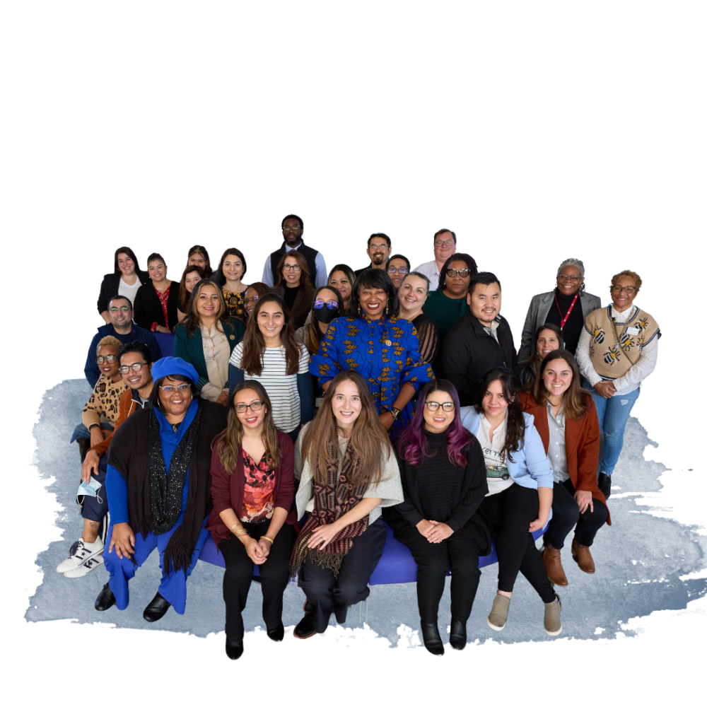 A diverse group of 29 people posed together against a blue watercolor background.