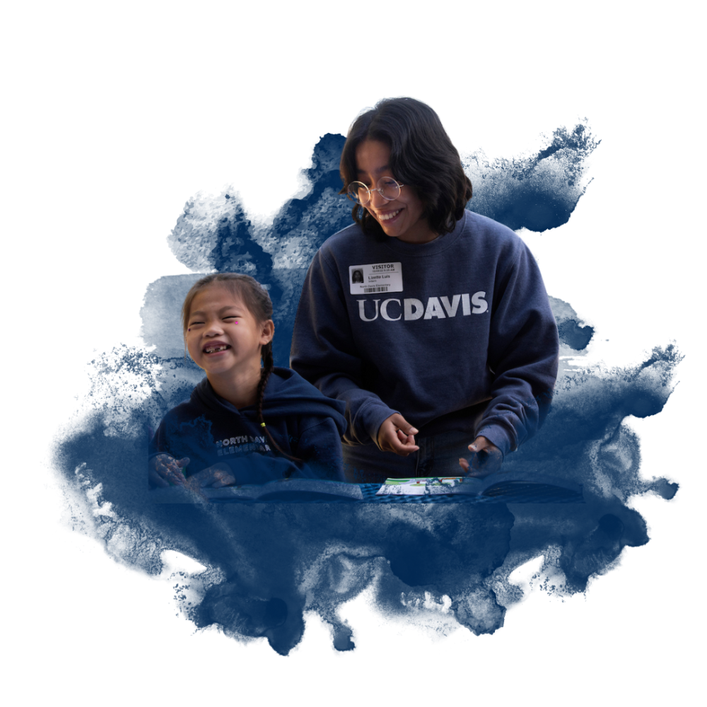A young girl and a young adult smiling with a blue ink splash background. The adult wears a "UC DAVIS" sweatshirt and glasses.