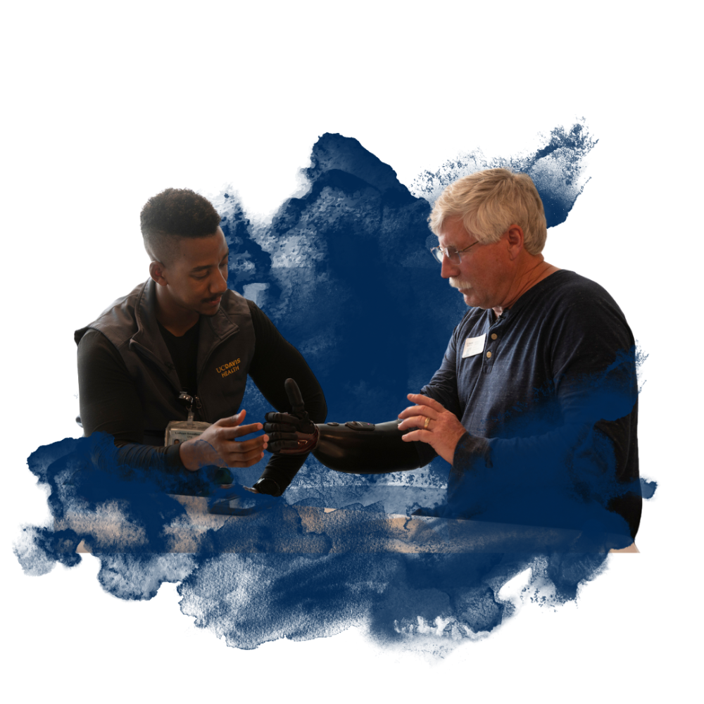 Two individuals interacting over a prosthetic device with a navy blue watercolor background.