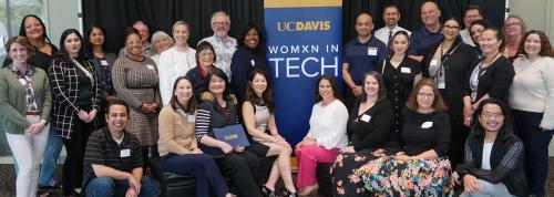 Attendees of the Womxn in Tech March 2024 event stand together.
