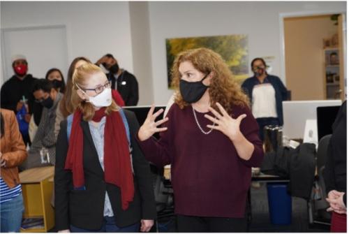 Lisa Materson (left) listens to Lorena Oropeza (right) speak at DEI open house