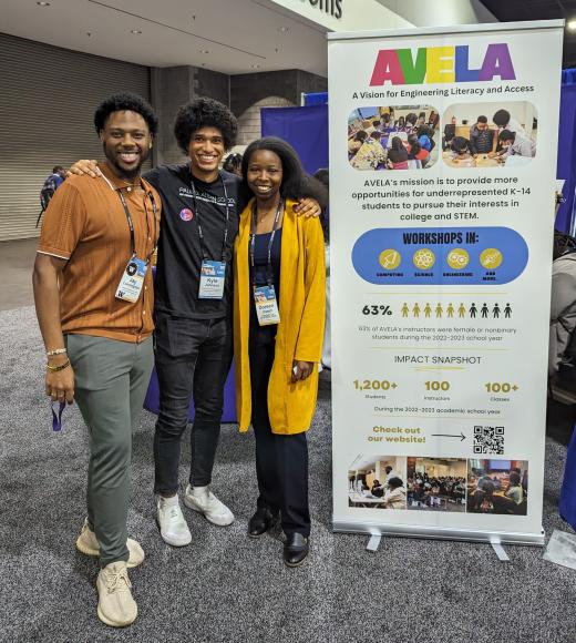 Doreen Joseph and two other students stand next to a poster that says AVELA