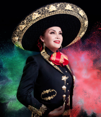 Aida Cuevas - female mariachi singer wearing mariachi costume and looking into the distance