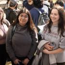 Three female students talk to bald man and another faculty member with glasses at Latino resource fair on main UC Davis quad.