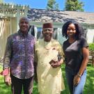 Chancellor May, Professor Augustine O. Esogbue and Doreen Joseph stand in courtyard at Chancellor's residence.