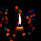 Candle with colored bokeh lights