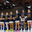womens basketball team stand side by side with arms linked. they are all wearing a tshirt that says black futures month