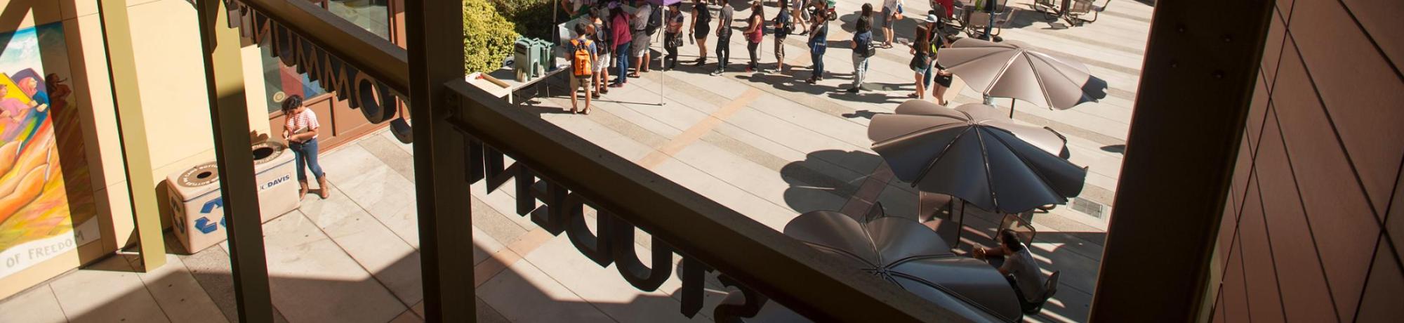 Student Community Center photographed from above, looking at students on campus