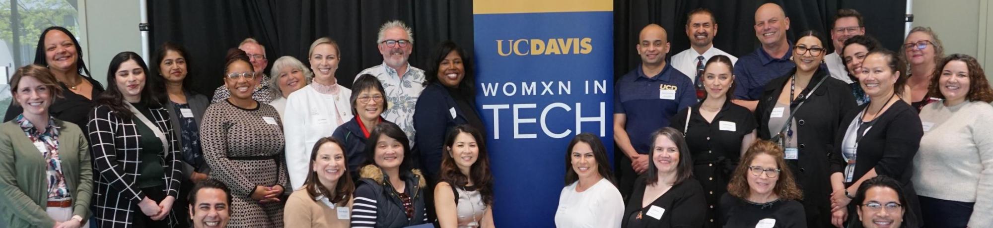 Attendees of the Womxn in Tech March 2024 event stand together.